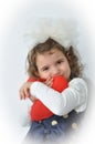 Young girl holding a pulsh red heart Royalty Free Stock Photo